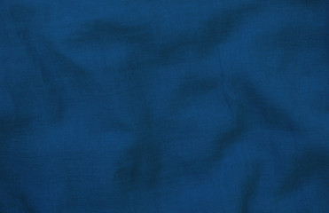 Fototapeta premium Crumpled blue fabric texture close up. Trendy tone of 2020 classic blue color