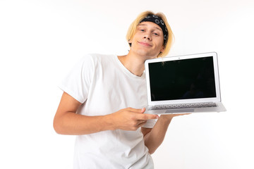 Stylish caucasian blonde man shows laptop isolated on white background