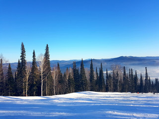 Alpine skiing. Snowboarding. View from the top of the mountain in sunny weather.