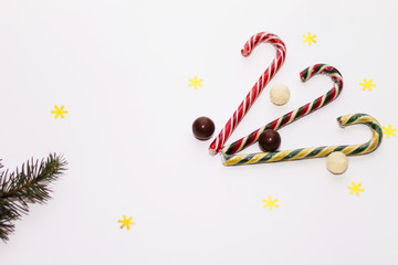 colorful candy lollipops, chocolate on white background, fir branch, new year, Christmas