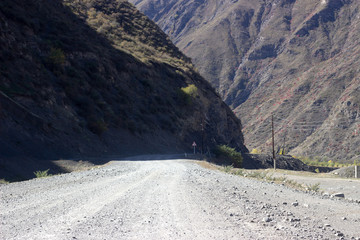 Rain Forest With A Dirt Road. Dirt road on the background of the rocky mountains