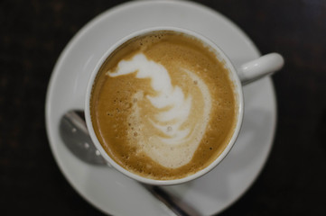 coffee with milk in a white Cup on a black background