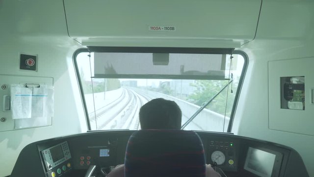 Rear view of train driver driving Jakarta LRT