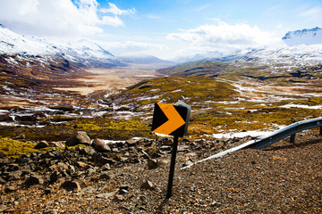 Road sign in front of a Icelandic valley.