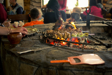 Cooking barbecue on an open fire.