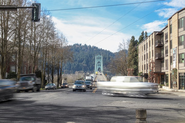 Long exposure of cars, trucks and people going over the famous St. Johns bridge in the afternoon.