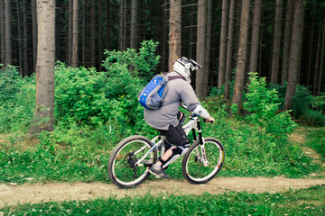 Young guy with a mountain bike in the Carpathians, Ukraine