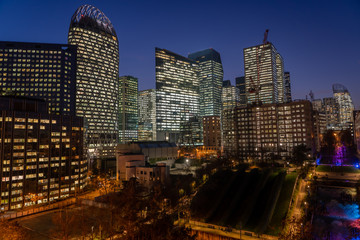 Fototapeta na wymiar Paris La Defense CBD skyline with lights on after sunset with city streets lights on and Parc Diderot lights