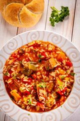 Roast pork meat with rice and vegtables on wooden background