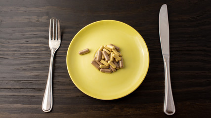 Suppliments overload or fasting with suppliments. Representation of taking too much suppliment that one can be full from just supplimentation.