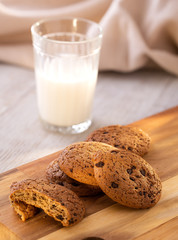 Oatmeal Cookies On A Wooden Board On A Sunny Day With A Glass Of Milk. Angle View.