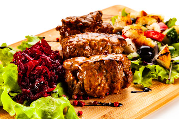 Wrapped pork with vegetables on white background