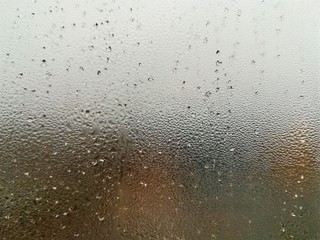 Misted glass. Blurred texture. Autumn rainy background.