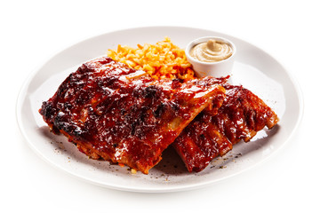 Barbecued ribs and vegetables on white background