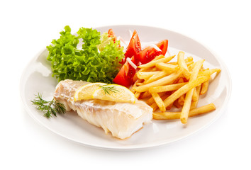 Fish dish - fried cod fillet with vegetables on white background