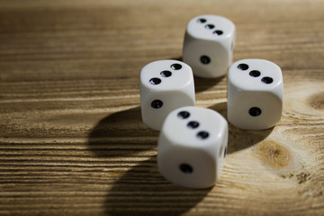 white dice on a wood background