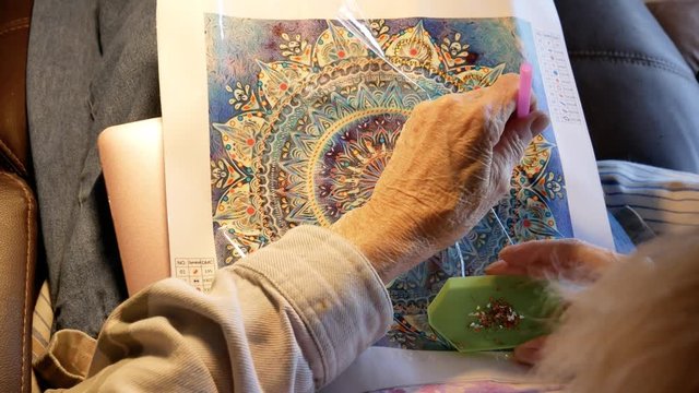 Senior Elderly Woman Passes Time With Diamond Painting
