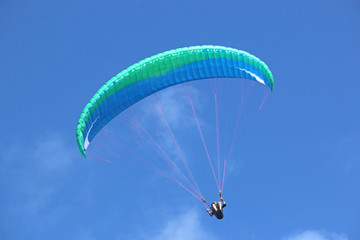 Paraglider flying wing in a blue sky	