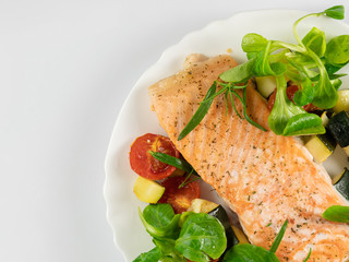 Delicious roasted fish served on white plate