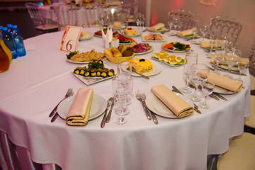 Festive table set with food. Snacks and utensils for a dinner party.