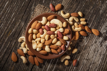 mixed nuts in a bowl on wooden table. Healthy food, organic food