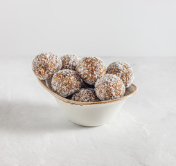 Homemade energy balls with dried apricots, raisins, walnuts, almonds and coconut. Healthy sweet food.