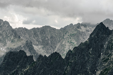 Alpine like mountain landscape of High Tatras, Slovakia. Kezmarsky stit, Lomnicky stit and other High Tatra peaks in autumn. Rocky mountains of High Tatras.