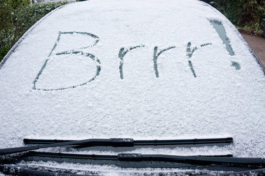Brrr written in the snow and ice of a car windscreen on a frosty winter monring