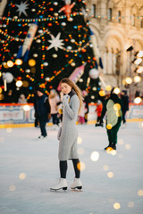 Beautiful woman is enjoy to be at ice-skate on the Red Square rink, Moscow, Russia