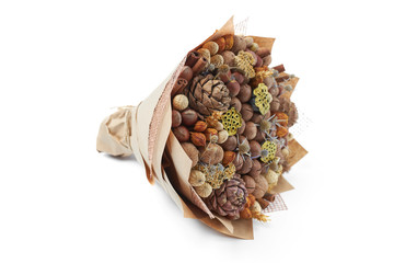Unique bouquet of different types of nuts on a white background