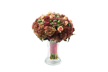 Lush bouquet of flowers and green feijoa fruits stands in a vase on a white background