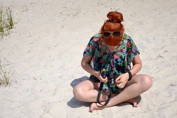 girl with a camera beautiful young woman girl on the beach red-haired girl