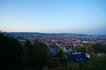 Germany, Skyline of city stuttgart in valley surrounded by hills covered by trees