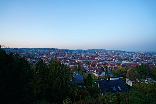 Germany, Skyline of city stuttgart in valley surrounded by hills covered by trees