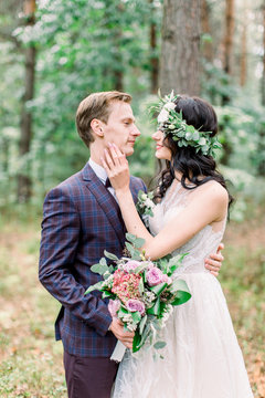 Bride and groom getting married in the forest. Rustic wedding photo