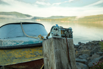 Fototapeta na wymiar Metal winch with attached fishing boat