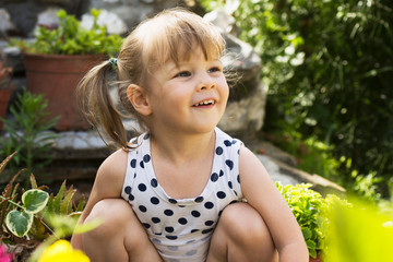 little girl playing in garden