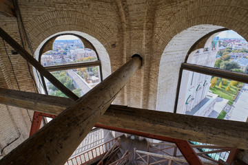 Cross wooden beams as reinforcement of the old construction of the upper part of the church tower