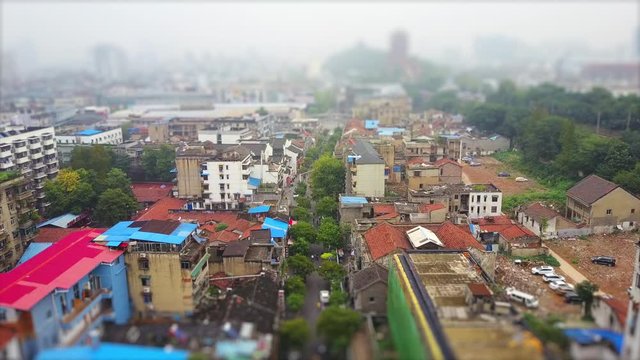 day time wuhan city slum living block yellow crane tample aerial panorama 4k tilt shift china