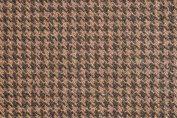 Seamless brown and black generic houndstooth fabric pattern background texture.