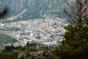 Obraz premium A view of Andorra La Vella from a hike high in the mountains around pine trees.