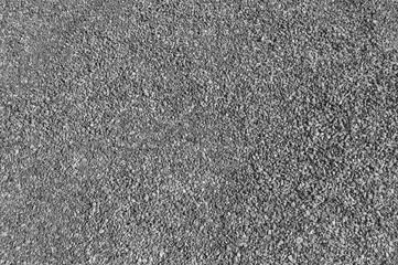Fine gravel used to cover tracks. Great background for any use. Black and white image.