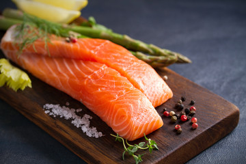 Fresh raw salmon fillet steak with vegetables and ingredients prepared for cooking