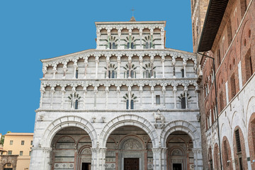 Romanesque Facade and bell tower of St. Martin  Cathedral in Lucca, Tuscany. It contains most precious relic in Lucca, Holy Face of Lucca