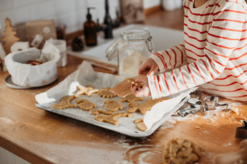 Child's hands making traditional Christmas cookies
