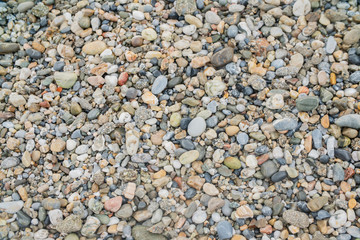 background surface of sea pebbles, stones and sand