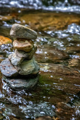 Fototapeta na wymiar Zen balancing pebbles from river stones stack. Tranquil Concept. Vertical view