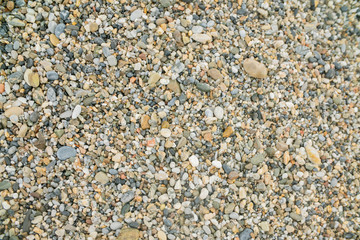 background surface of sea pebbles, stones and sand