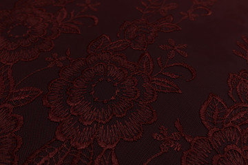Closeup of red fabric with floral pattern and textile texture background