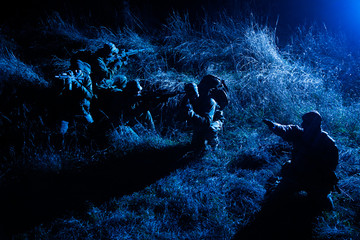 Army tactical group fighters sneaking in darkness